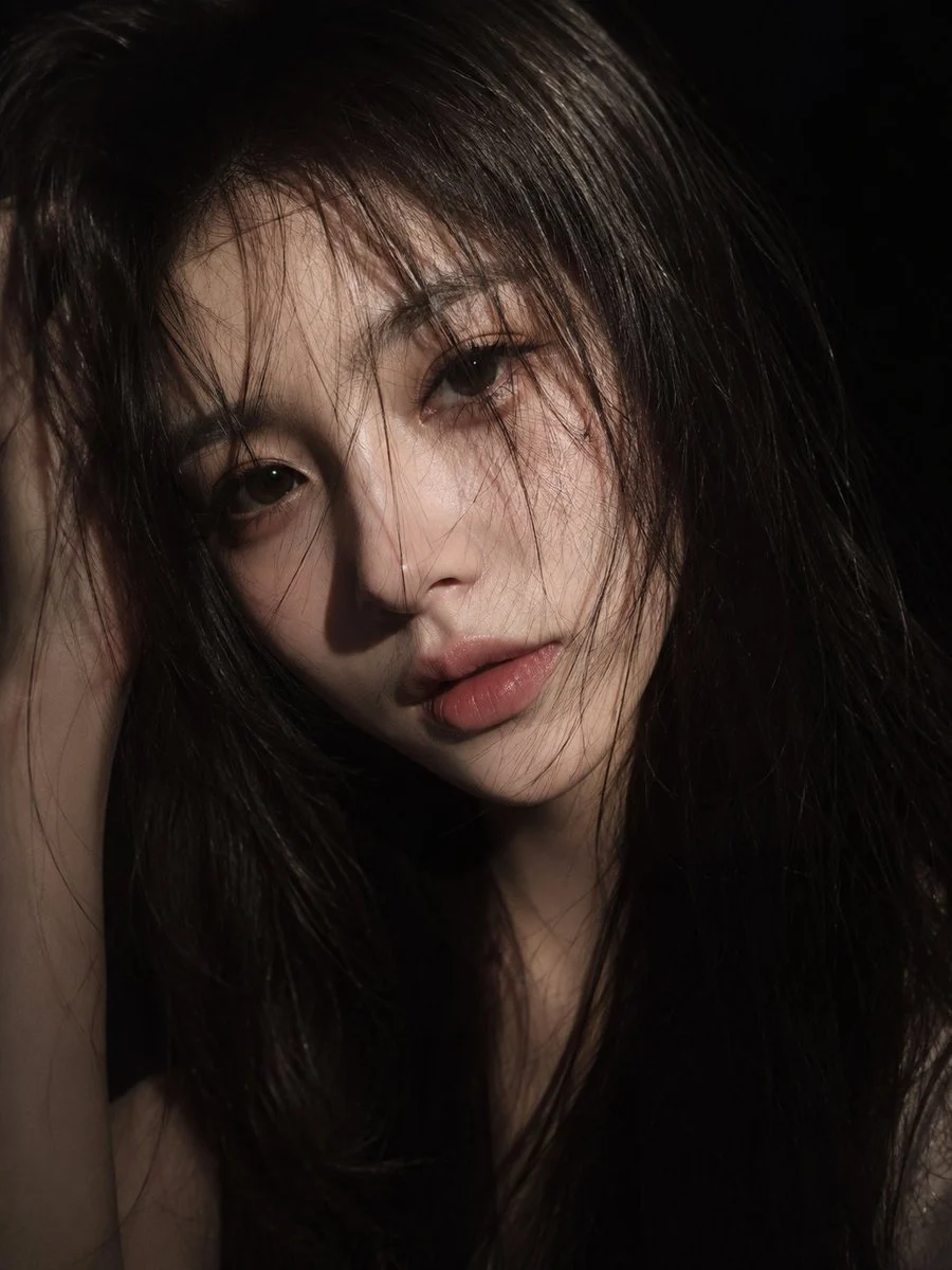 Cinematic Low-Key East Asian Portrait with realistic portrait lighting, expressive subject detail and polished editorial photography