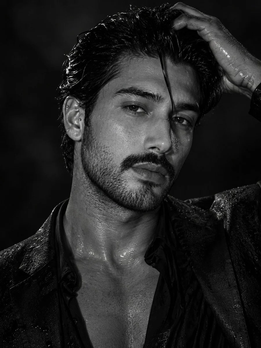 Cinematic monochrome male portrait with sharp facial detail, deep shadows, and sophisticated fashion lighting