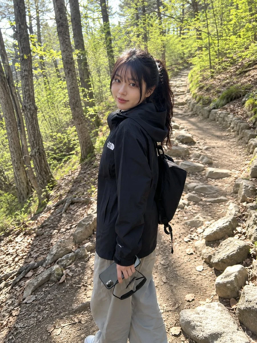Candid mobile hiking snapshot with casual outdoor outfit, forest trail setting, and natural social-media realism