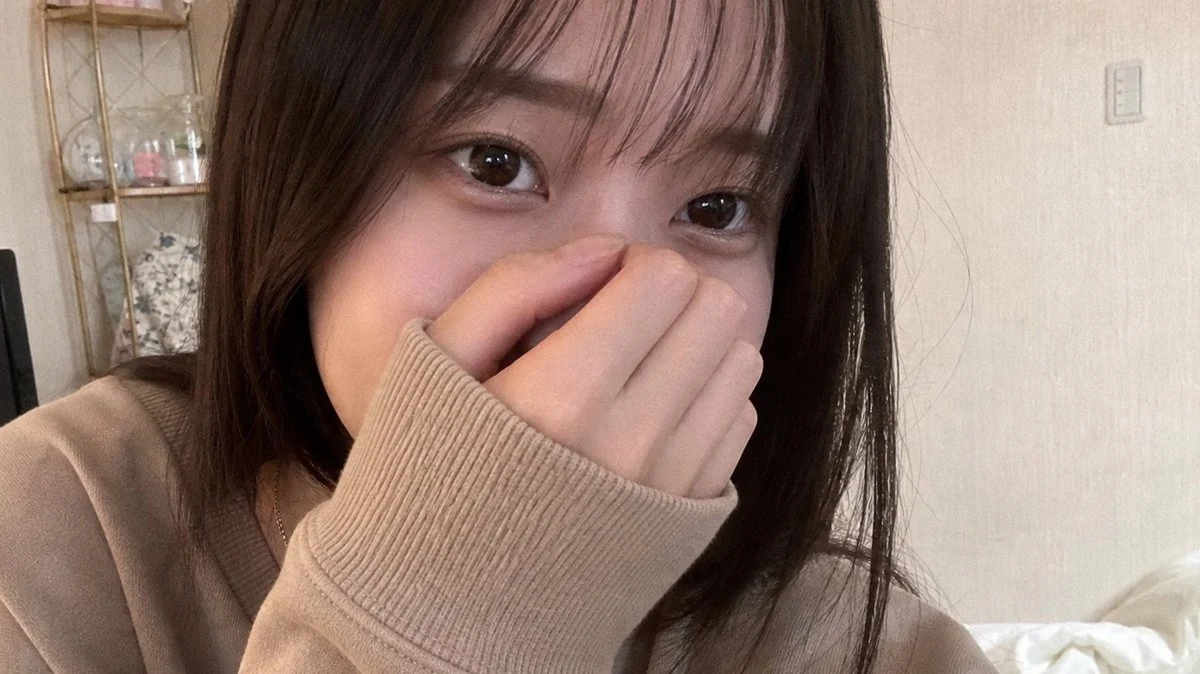 Realistic shy bedroom selfie portrait with soft indoor lighting, natural skin texture, and a candid smartphone-photo mood.