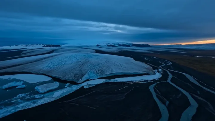Aerial Iceland glacier landscape cracks open with lava and volcanic steam