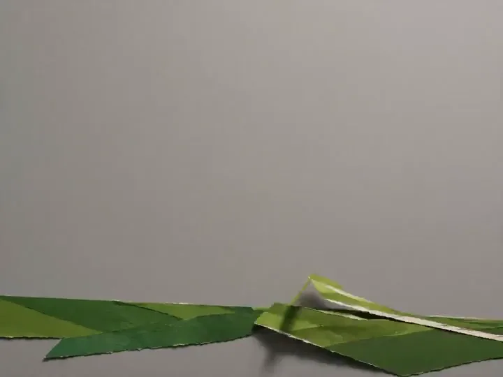 Stop-motion paper craft layers assemble into a sports poster scene